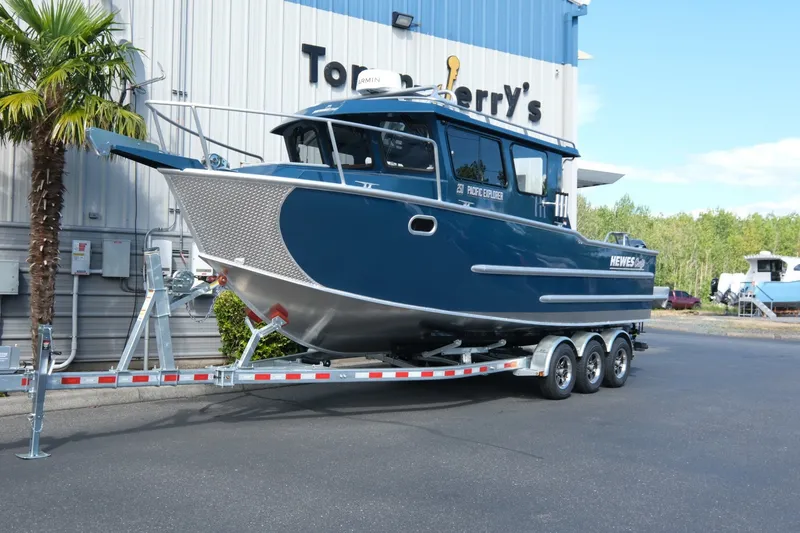The Image of 2026 Hewescraft 250 Pacific Explorer boat on trailer outside dealership. - 3