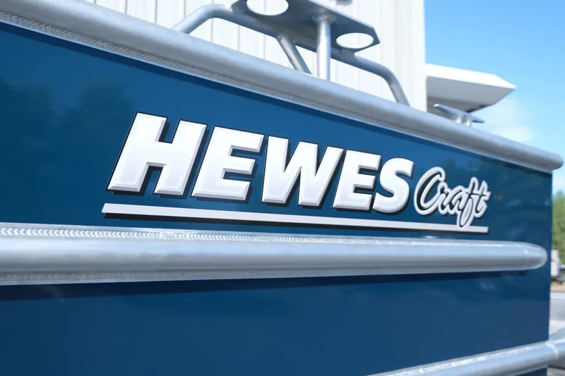 Slide: The Image of 2026 Hewescraft 250 Pacific Explorer boat logo on blue exterior. - 25