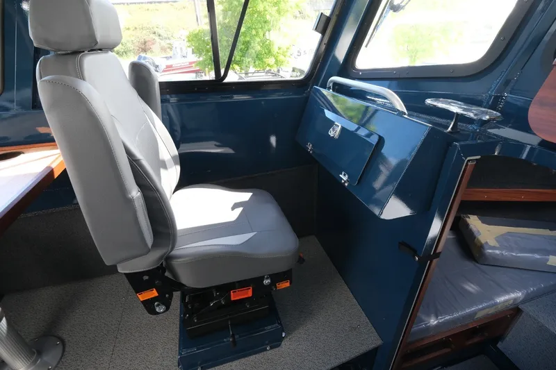 Slide: The Image of Interior of 2026 Hewescraft 250 Pacific Explorer, featuring a comfortable captain's chair and control panel. - 18