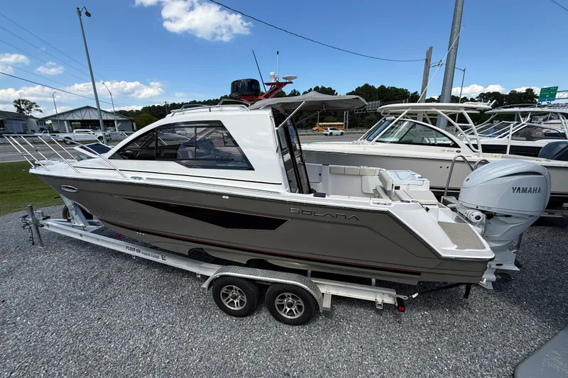 Slide: The Image of 2026 Solara S-250 C boat on trailer, featuring sleek design and Yamaha outboard motor. - 2