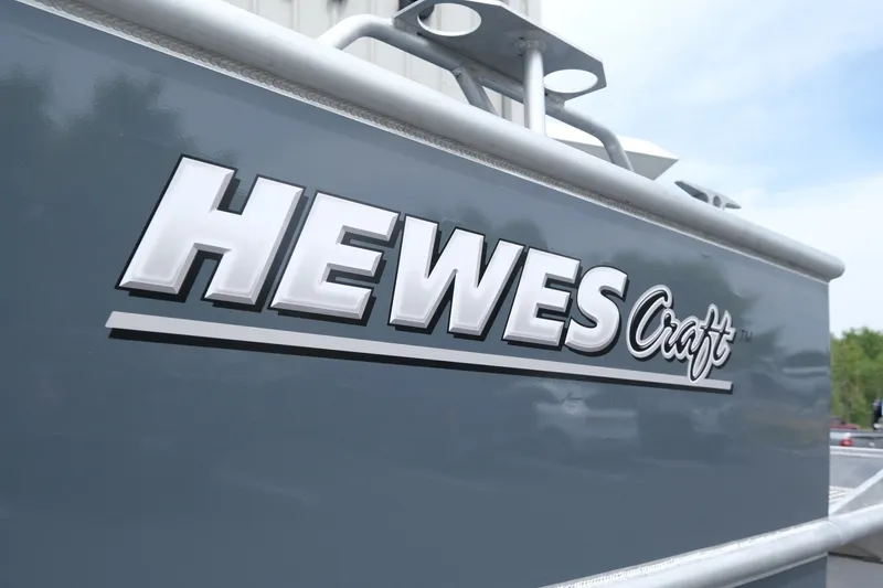 Slide: The Image of 2026 Hewescraft 250 Alaskan boat logo on sleek gray exterior. - 23