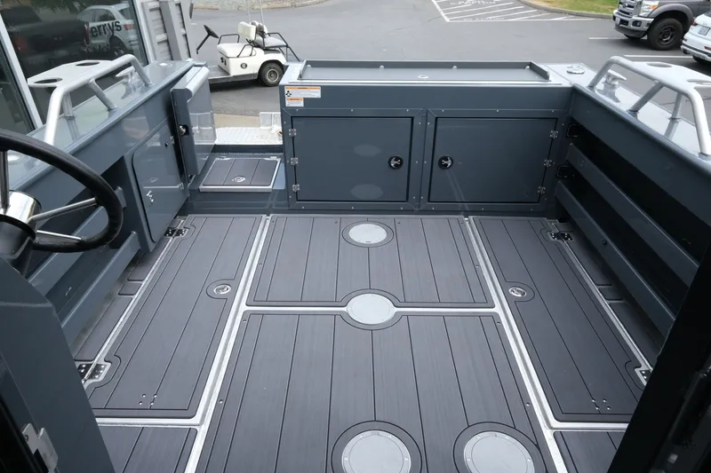 Slide: The Image of 2026 Hewescraft 250 Alaskan boat interior with spacious deck and storage compartments. - 19