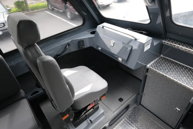 Slide: The Image of 2026 Hewescraft 250 Alaskan interior with gray seating and storage compartments. - 16