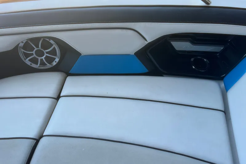 Slide: The Image of Interior seating of 2019 Yamaha Boats 212X with speaker and blue accents. - 22