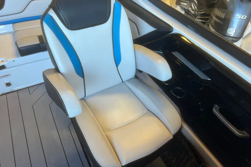 Slide: The Image of 2019 Yamaha Boats 212X interior with white and blue seating, showcasing modern design. - 9