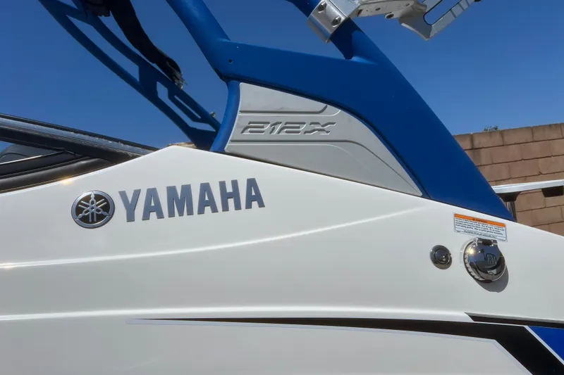 Slide: The Image of 2019 Yamaha Boats 212X, white and blue design, close-up view. - 11