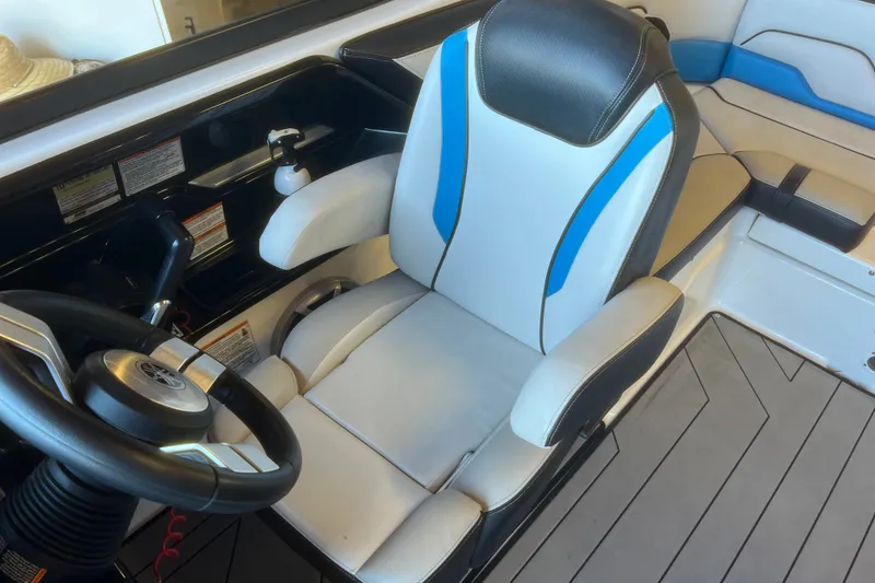 Slide: The Image of 2019 Yamaha Boats 212X cockpit with steering wheel and cushioned seat. - 10