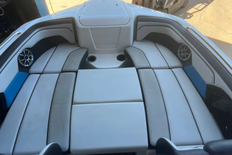 Slide: The Image of Interior seating of a 2019 Yamaha Boats 212X, featuring cushioned seats and built-in speakers. - 7
