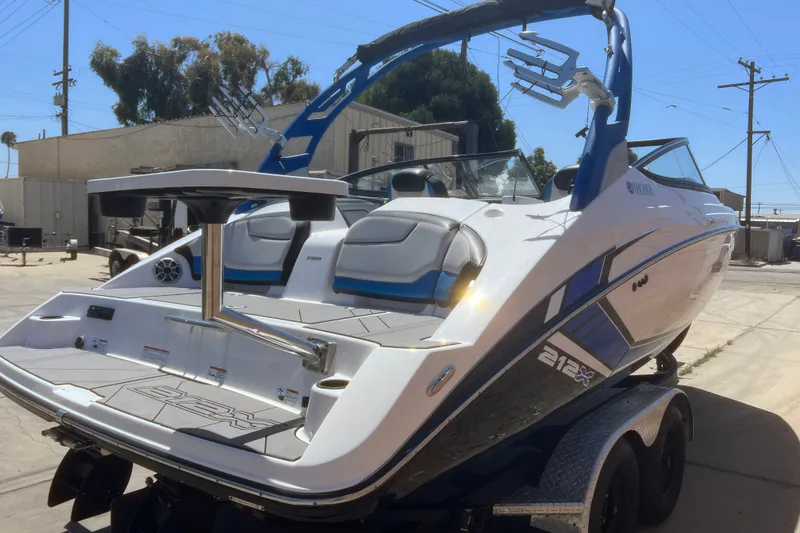 Slide: The Image of 2019 Yamaha Boats 212X on trailer, featuring sleek design and modern amenities. - 17