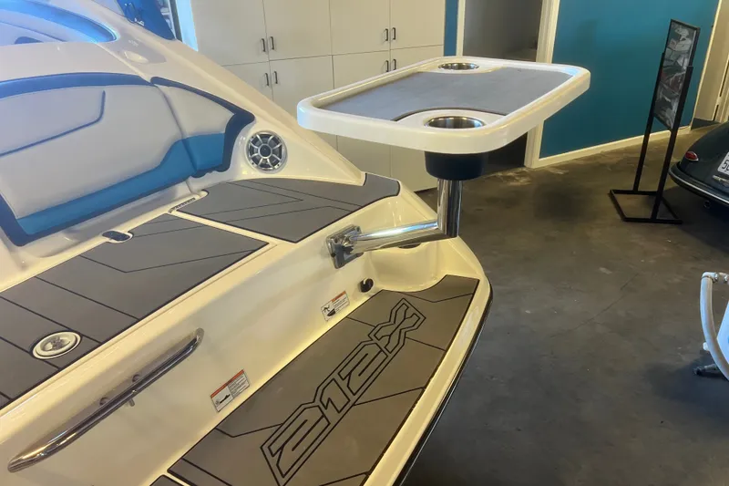 Slide: The Image of 2019 Yamaha Boats 212X with swim platform and mounted table in showroom. - 5