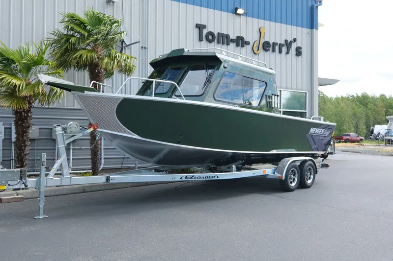 The Image of 2026 Hewescraft 240 Ocean Pro ET Hardtop boat on trailer outside dealership. - 1
