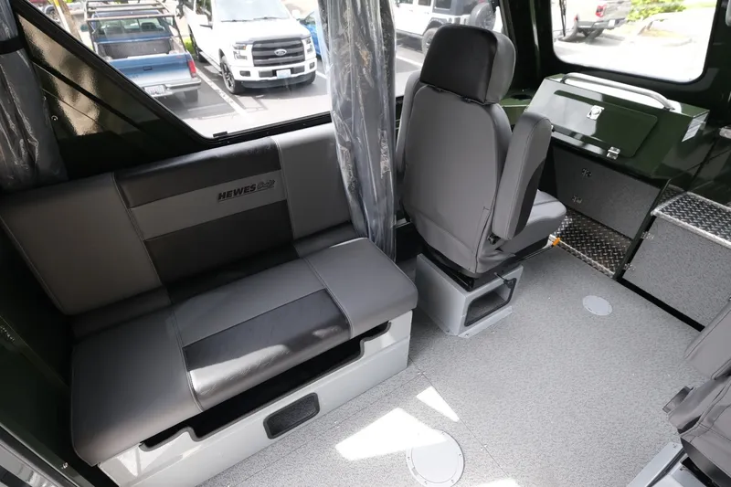 Slide: The Image of Interior of 2026 Hewescraft 240 Ocean Pro ET Hardtop, featuring seating and storage. - 10