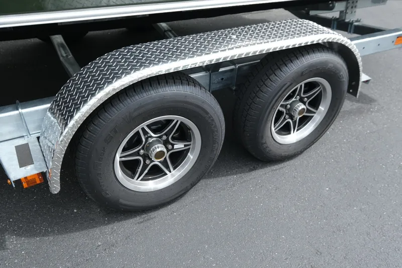 Slide: The Image of Trailer wheels of 2026 Hewescraft 240 Ocean Pro ET Hardtop, featuring diamond plate fenders. - 18