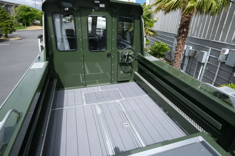 Slide: The Image of 2026 Hewescraft 240 Ocean Pro ET Hardtop boat interior with green exterior and spacious deck. - 6