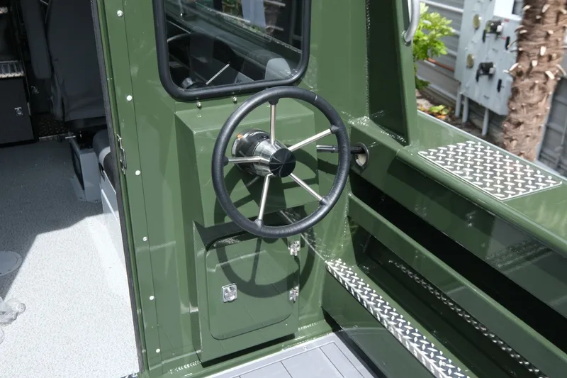 Slide: The Image of Steering wheel of 2026 Hewescraft 240 Ocean Pro ET Hardtop, featuring green exterior. - 8