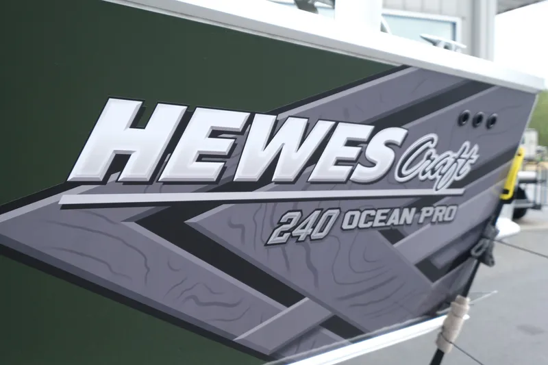 Slide: The Image of 2026 Hewescraft 240 Ocean Pro ET Hardtop boat logo on green hull. - 19
