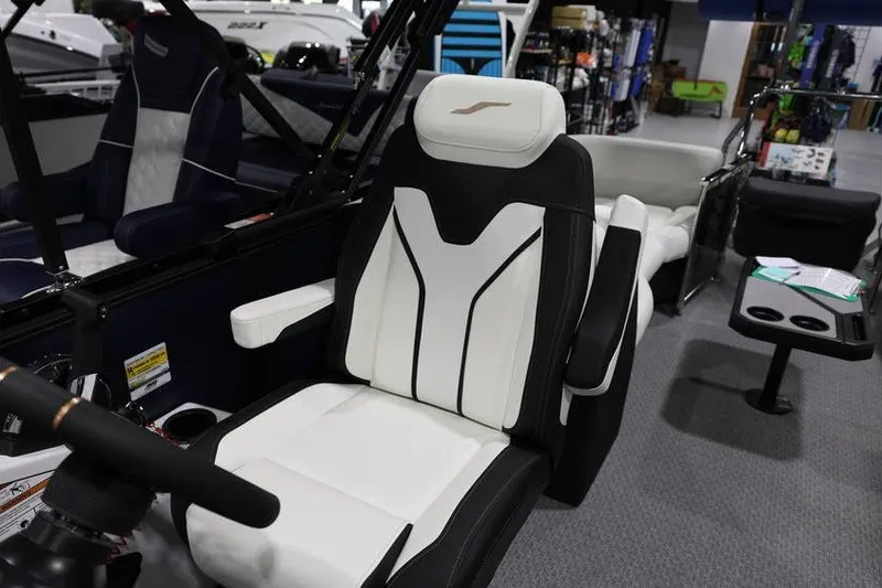 Slide: The Image of Captain's chair in a 2026 Evotti 723QL boat, featuring sleek black and white design. - 19