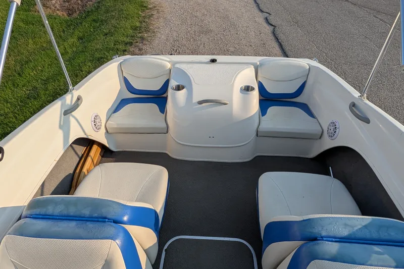 Slide: The Image of 2007 Bayliner 175 Bowrider interior with blue and white seating, cup holders, and speakers. - 17