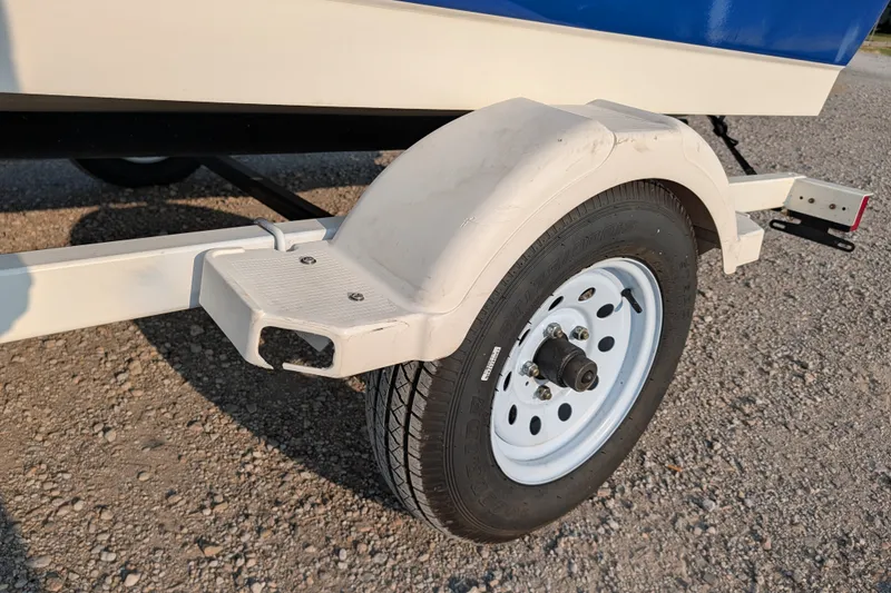 Slide: The Image of Trailer wheel of a 2007 Bayliner 175 Bowrider on gravel surface. - 23