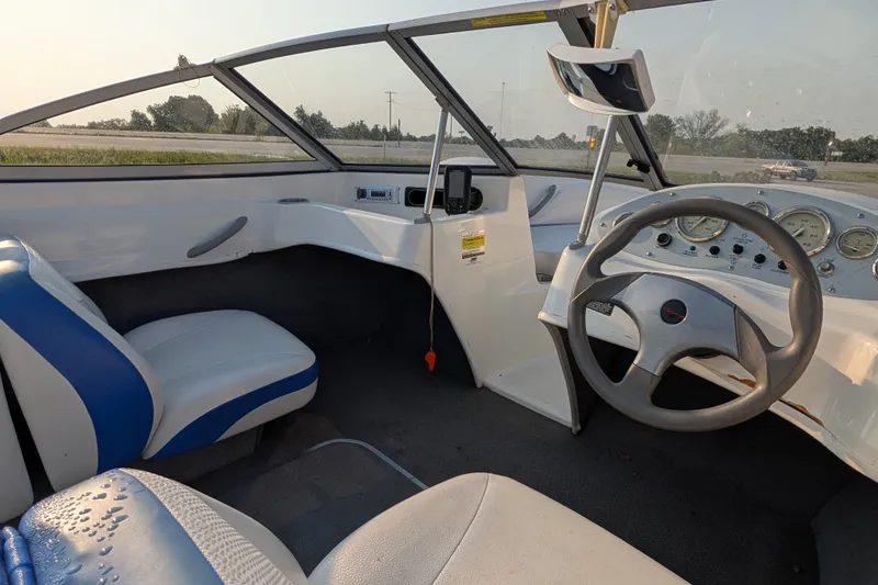 Slide: The Image of Interior of a 2007 Bayliner 175 Bowrider boat with steering wheel and seating. - 14