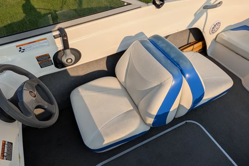 Slide: The Image of 2007 Bayliner 175 Bowrider interior with blue and white seating and steering wheel. - 19