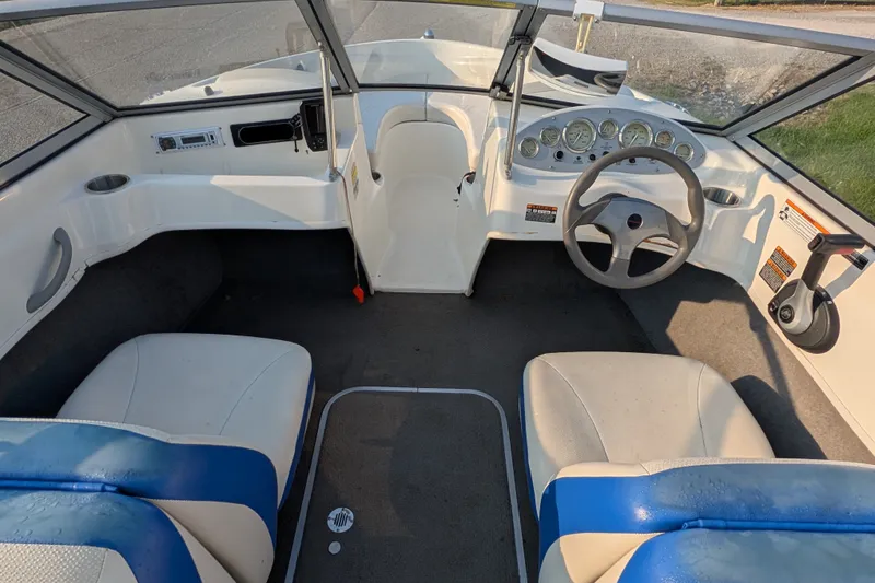 Slide: The Image of Interior view of a 2007 Bayliner 175 Bowrider boat, featuring steering wheel and seating. - 15