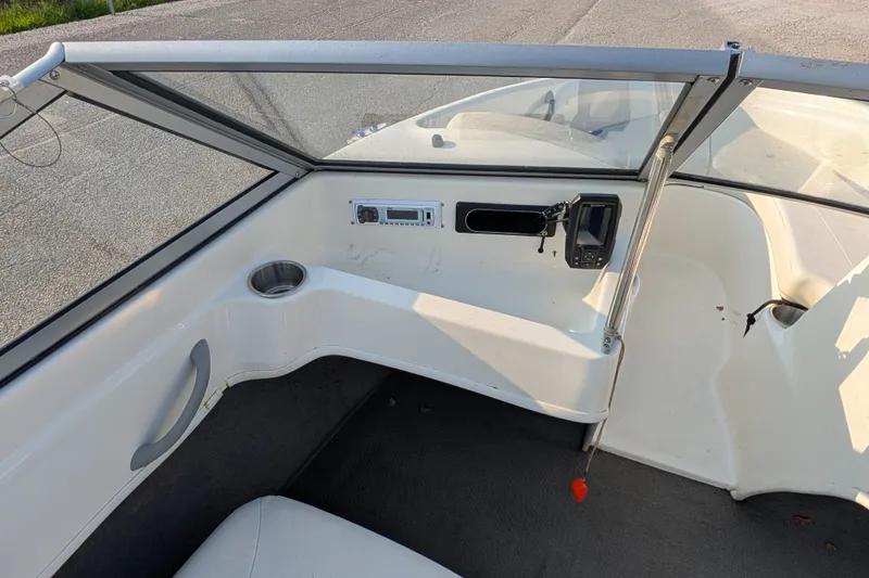 Slide: The Image of 2007 Bayliner 175 Bowrider interior with dashboard, cup holder, and navigation equipment. - 21