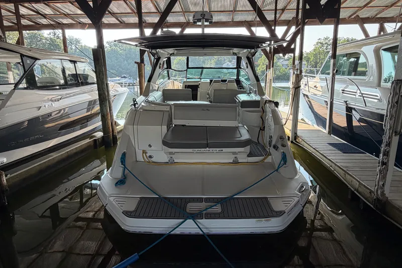 Slide: The Image of 2020 Sea Ray Sundancer 320 docked in a marina, surrounded by other boats. - 5
