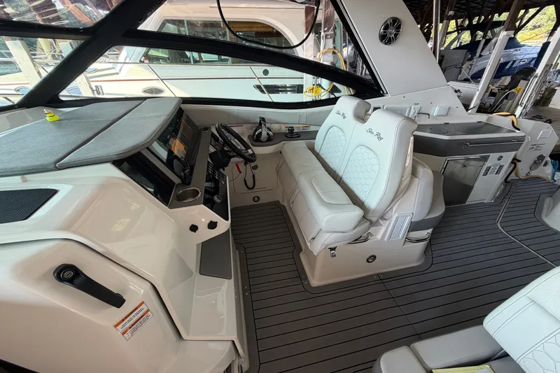 Slide: The Image of 2020 Sea Ray Sundancer 320 cockpit with modern helm, plush seating, and sleek design. - 19