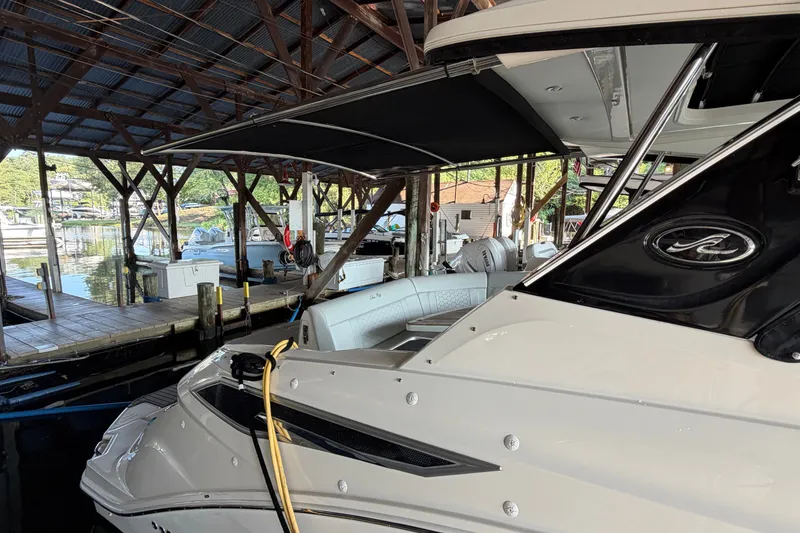 Slide: The Image of 2020 Sea Ray Sundancer 320 docked under a covered marina. - 1