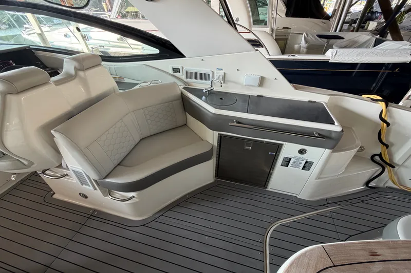 Slide: The Image of 2020 Sea Ray Sundancer 320 interior with seating and kitchenette on deck. - 3
