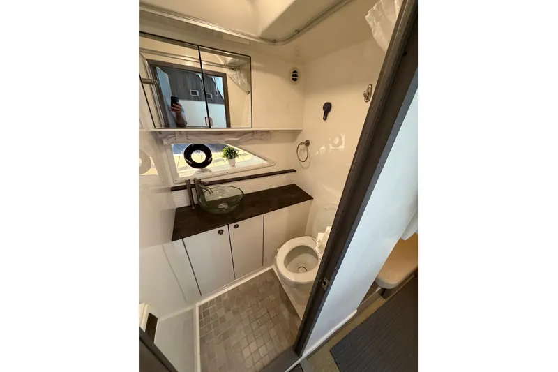 Slide: The Image of Modern bathroom in 2020 Sea Ray Sundancer 320 yacht with sleek fixtures and compact design. - 17