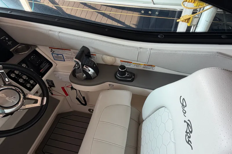 Slide: The Image of Interior of 2020 Sea Ray Sundancer 320 boat, featuring steering wheel and control panel. - 23