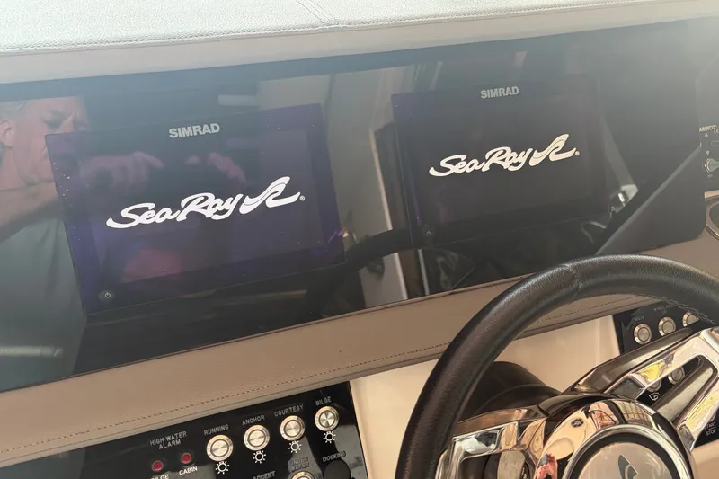 Slide: The Image of Dashboard of a 2020 Sea Ray Sundancer 320 with Simrad displays. - 16