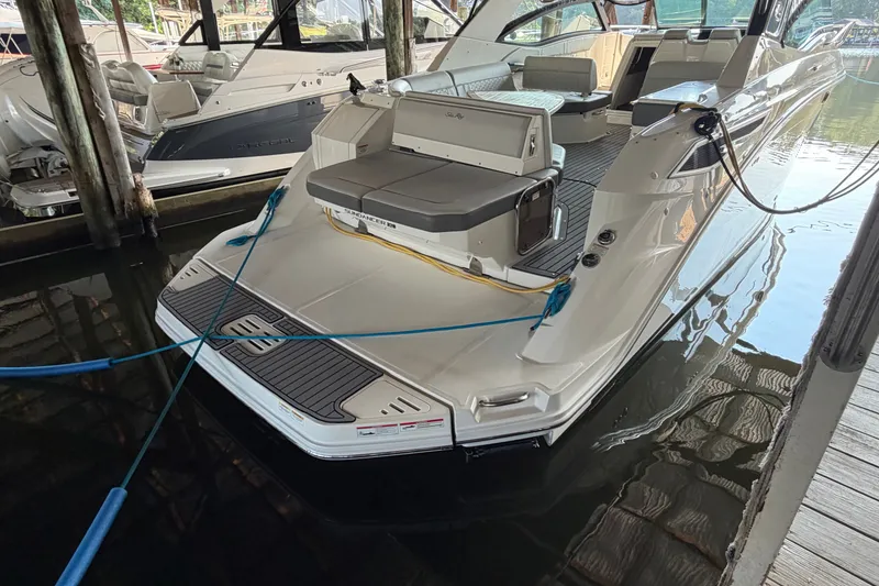 Slide: The Image of 2020 Sea Ray Sundancer 320 docked, showcasing sleek design and spacious seating area. - 6