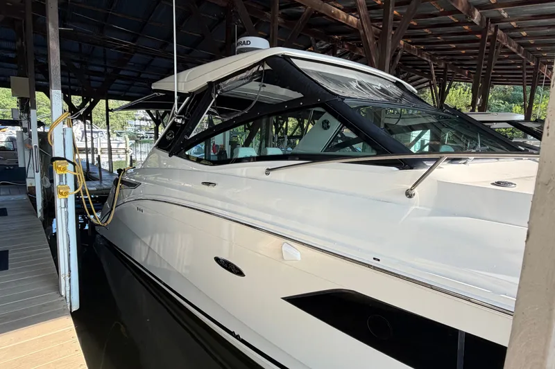 Slide: The Image of 2020 Sea Ray Sundancer 320 docked under a covered marina. - 7