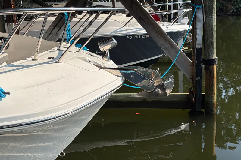 Slide: The Image of 2020 Sea Ray Sundancer 320 docked with anchor and blue ropes visible. - 8