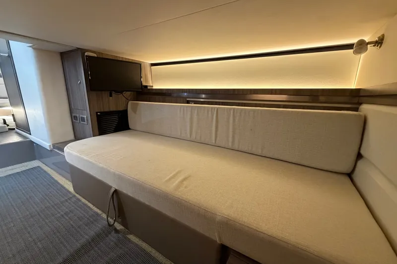 Slide: The Image of Interior of 2020 Sea Ray Sundancer 320 yacht with beige seating and wall-mounted TV. - 32