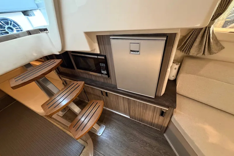 Slide: The Image of Interior of 2020 Sea Ray Sundancer 320 with stairs, fridge, and microwave. - 14