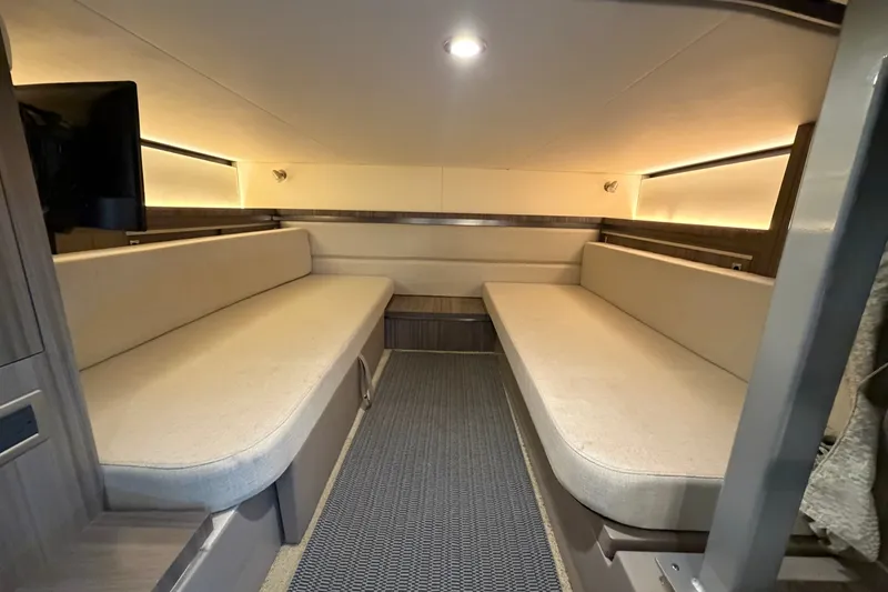 Slide: The Image of Interior of 2020 Sea Ray Sundancer 320, featuring cozy seating and modern lighting. - 27