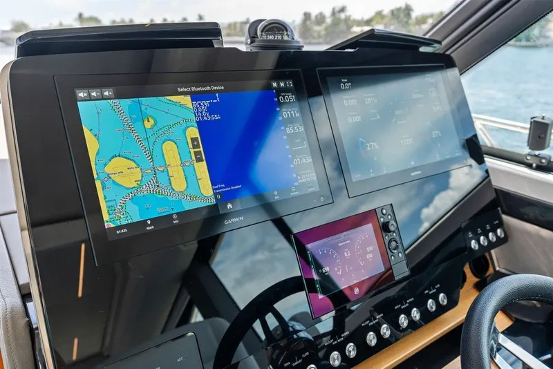 Slide: The Image of 2024 Tiara 48 LE yacht dashboard with advanced navigation and control screens. - 46