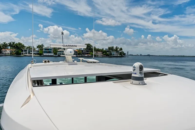 Slide: The Image of 2024 Tiara 48 LE yacht with Garmin equipment, cruising on a sunny day. - 19