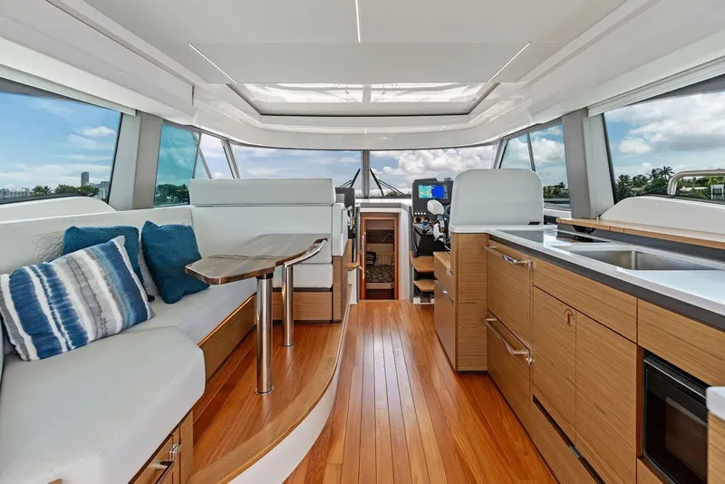 Slide: The Image of Luxurious interior of 2024 Tiara 48 LE yacht with modern seating and kitchen area. - 37