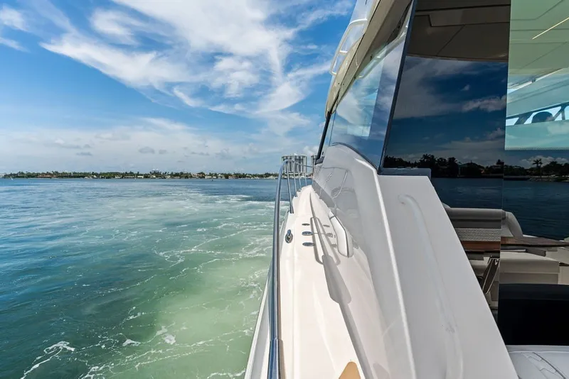 Slide: The Image of 2024 Tiara 48 LE yacht cruising on a sunny day with clear blue skies. - 20