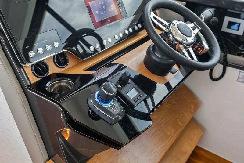 Slide: The Image of Helm of 2024 Tiara 48 LE yacht with modern controls and steering wheel. - 47