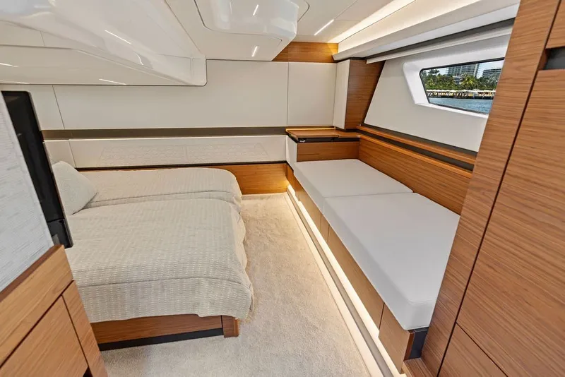 Slide: The Image of Luxurious interior of 2024 Tiara 48 LE yacht with modern wood finishes and cozy seating. - 55