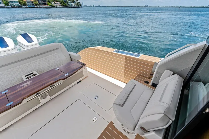 Slide: The Image of Luxurious 2024 Tiara 48 LE yacht deck with seating, table, and scenic water view. - 27