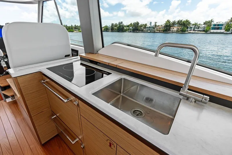 Slide: The Image of Modern kitchen area on 2024 Tiara 48 LE yacht with sink and stovetop. - 41