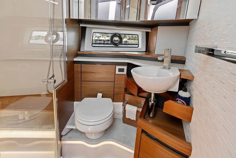 Slide: The Image of Luxurious 2024 Tiara 48 LE yacht bathroom with modern fixtures and elegant wood accents. - 59