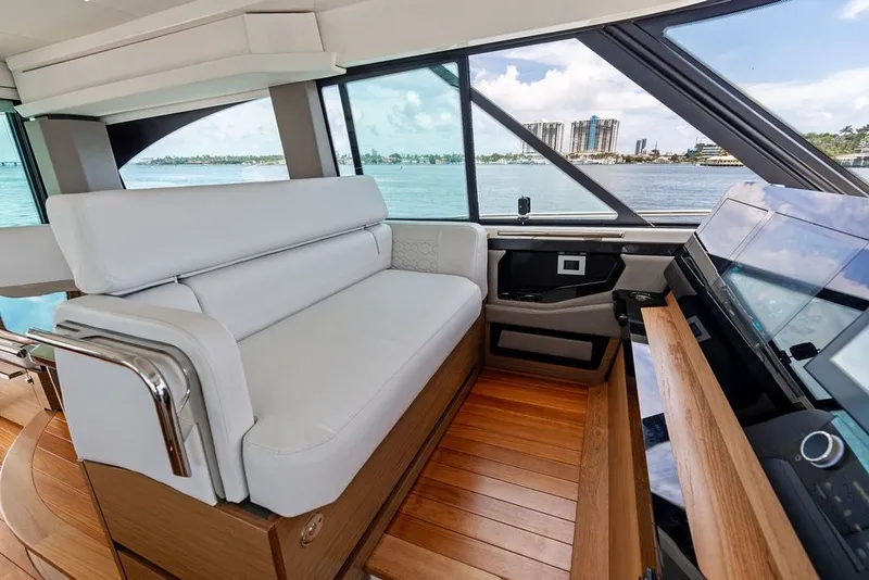 Slide: The Image of Interior of 2024 Tiara 48 LE yacht with white seating and wooden flooring. - 42